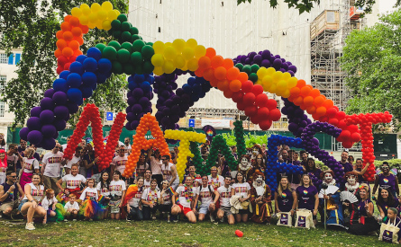 The word 'Natwest' in rainbow colours held aloft by members of the Rainbow Network